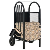 Black steel firewood cart with wheels, holding stacked logs and including poker, brush, and shovel.